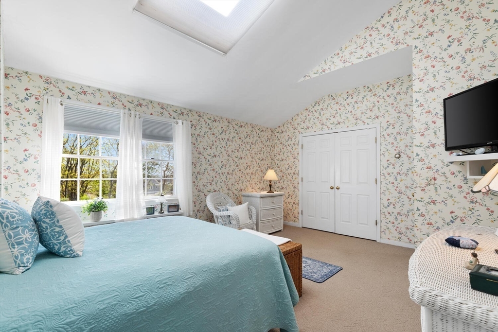 8 Oxford Road Gloucester, MA 01930 - Photo 25 of 35 a spacious bedroom with a bed and a flat screen tv