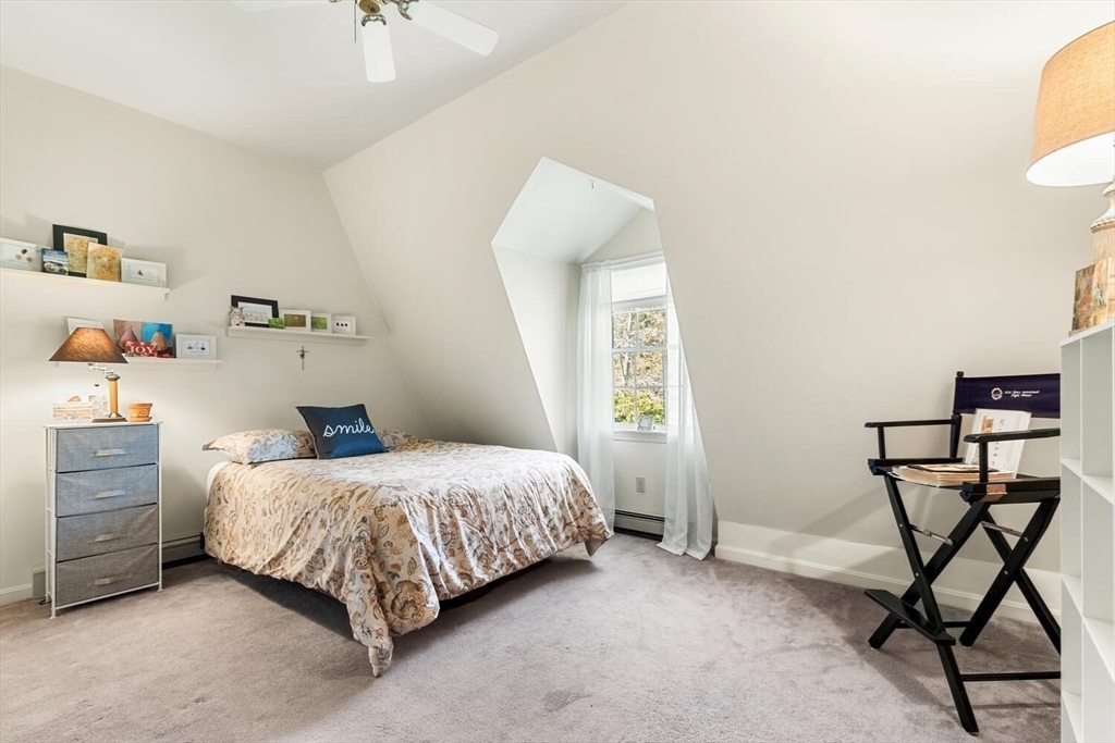 8 Oxford Road Gloucester, MA 01930 - Photo 28 of 35 a bedroom with a bed and a table in it