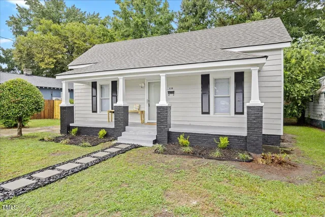 a aerial view of a house with yard and sitting area