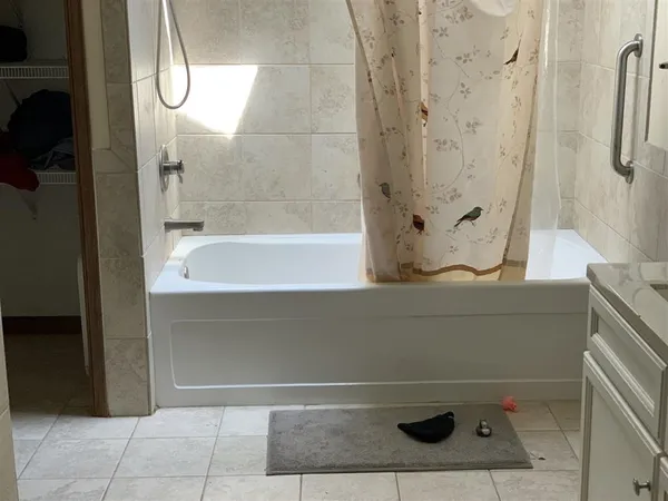 a bathroom with a bathtub and shower