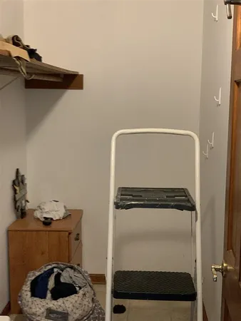 a view of storage and utility room with two washing machine
