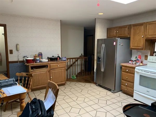 a kitchen with a refrigerator and a stove top oven