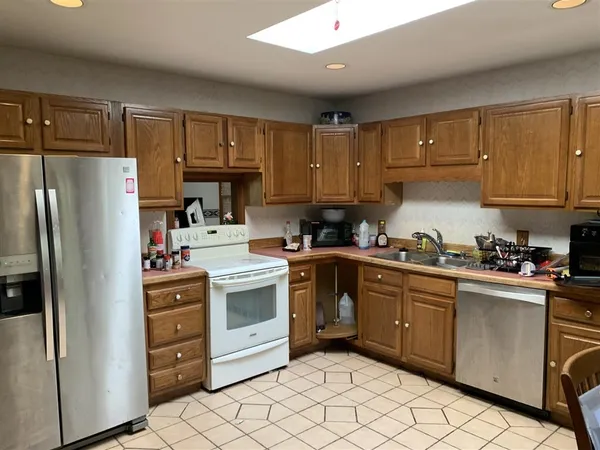 a kitchen with cabinets appliances and a window