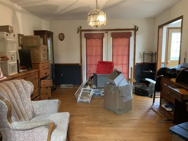 a living room with furniture a chandelier a fireplace and a chandelier