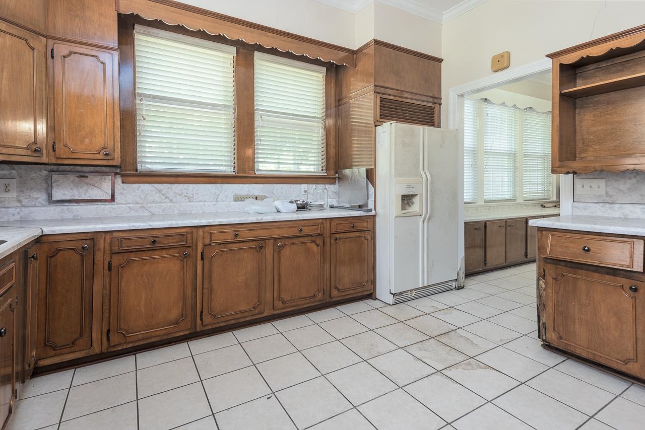 1374 Farrow Road Memphis, TN 38116 - Photo 13 of 34 Kitchen with a wealth of natural light, backsplash, white refrigerator with ice dispenser, and light tile patterned floors
