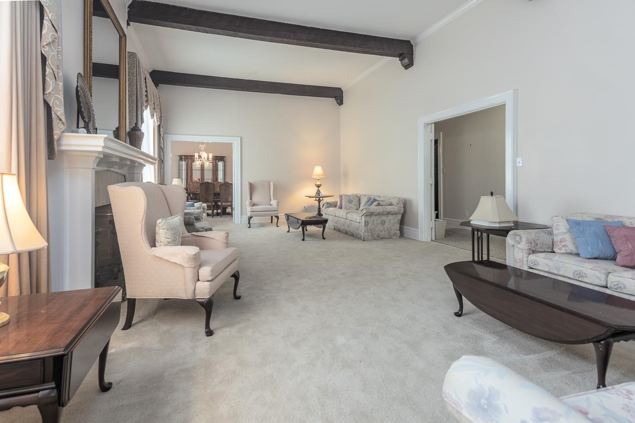 1374 Farrow Road Memphis, TN 38116 - Photo 8 of 34 Carpeted living room with beamed ceiling and a chandelier