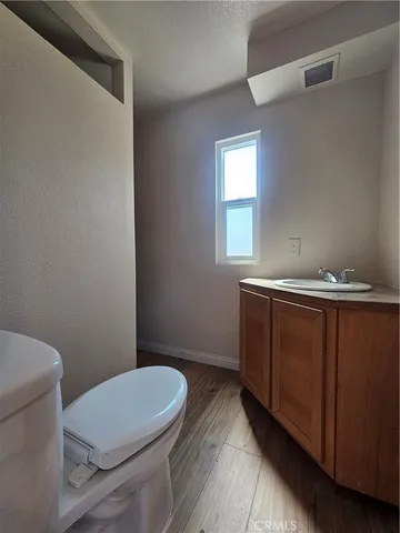 a bathroom with a toilet a sink and mirror