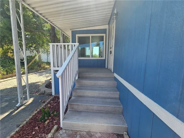 a view of staircase with wooden floor and white walls