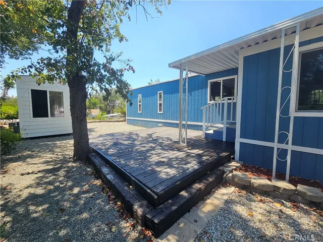 a view of a backyard with a large tree