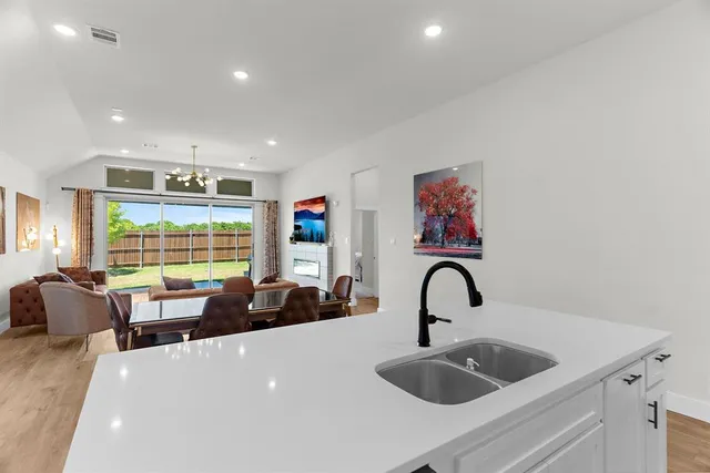 a kitchen with a large window and sink