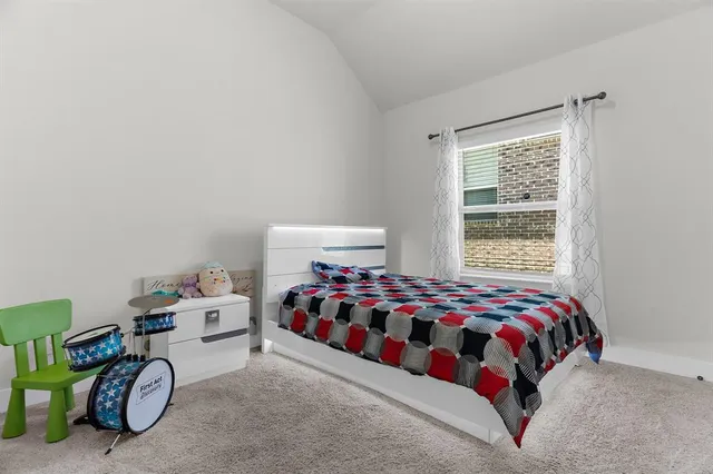 a bedroom with bed and a window