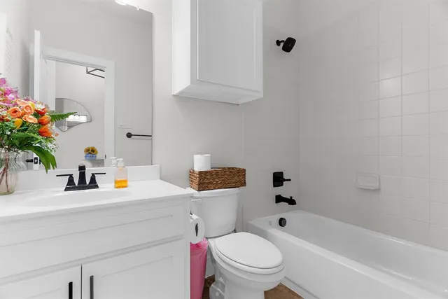 a bathroom with a sink toilet and shower