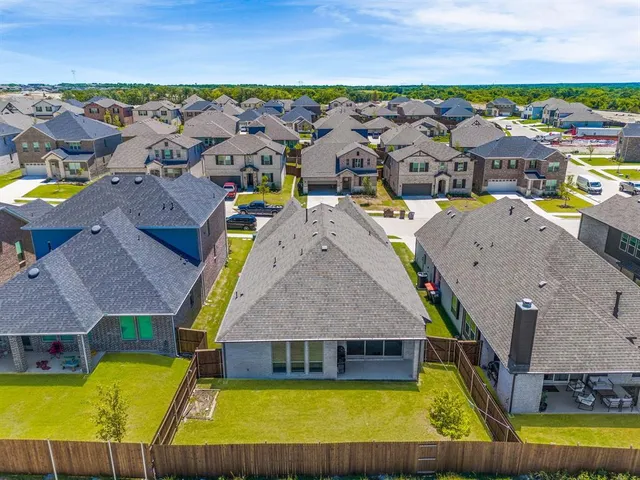 an aerial view of a house with a swimming pool