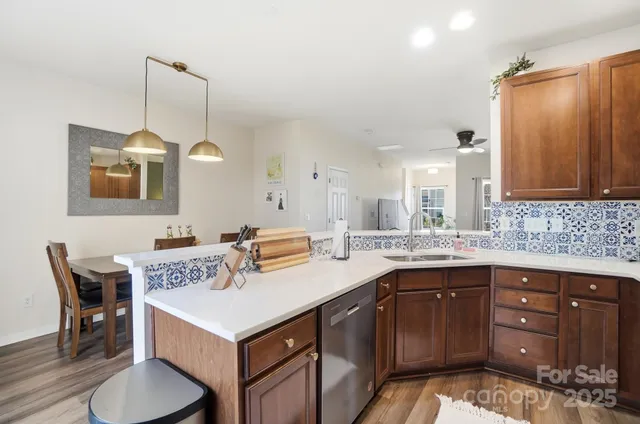 a kitchen that has a lot of cabinets in it and wooden floors
