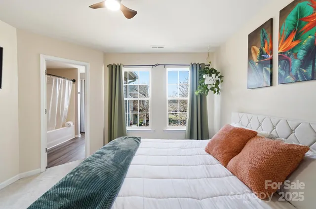 a bedroom with a large bed and a window