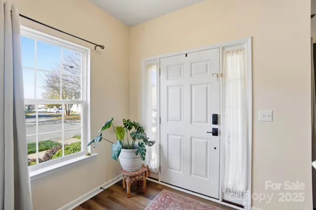 a room with window wooden floor and table chair
