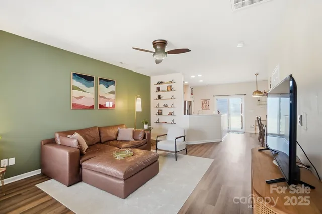 a living room with furniture and a chandelier