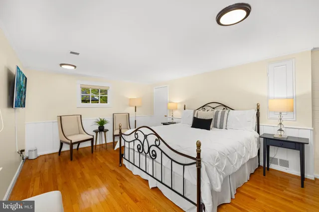 a bedroom with a bed a table and chair