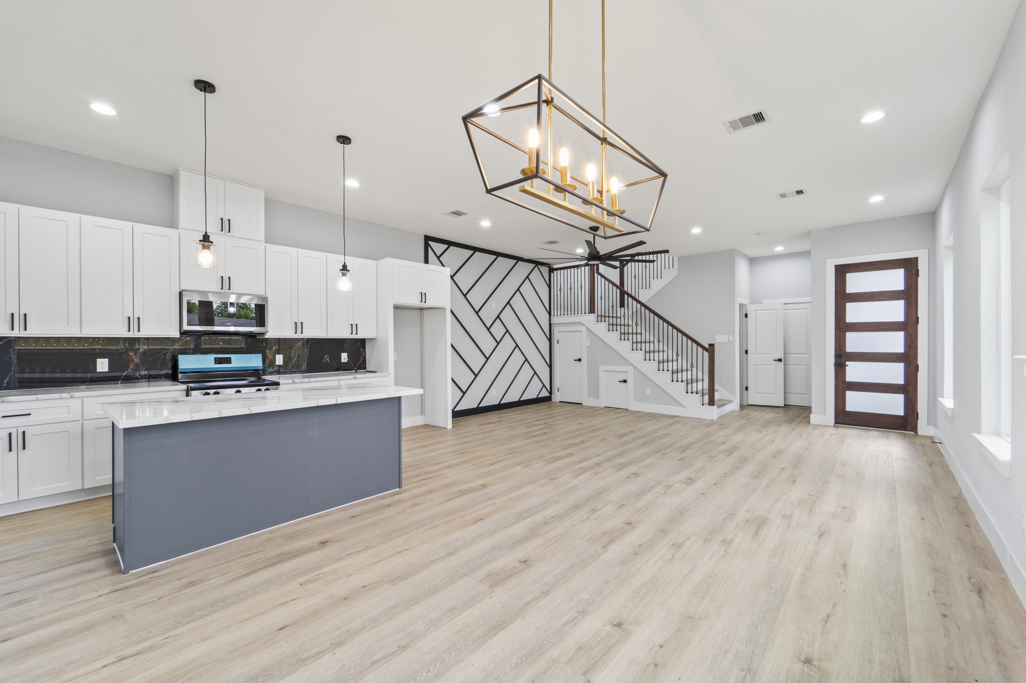 6631 Foster Street Houston, TX 77021 - Photo 11 of 31 a kitchen with kitchen island a sink and wooden floor