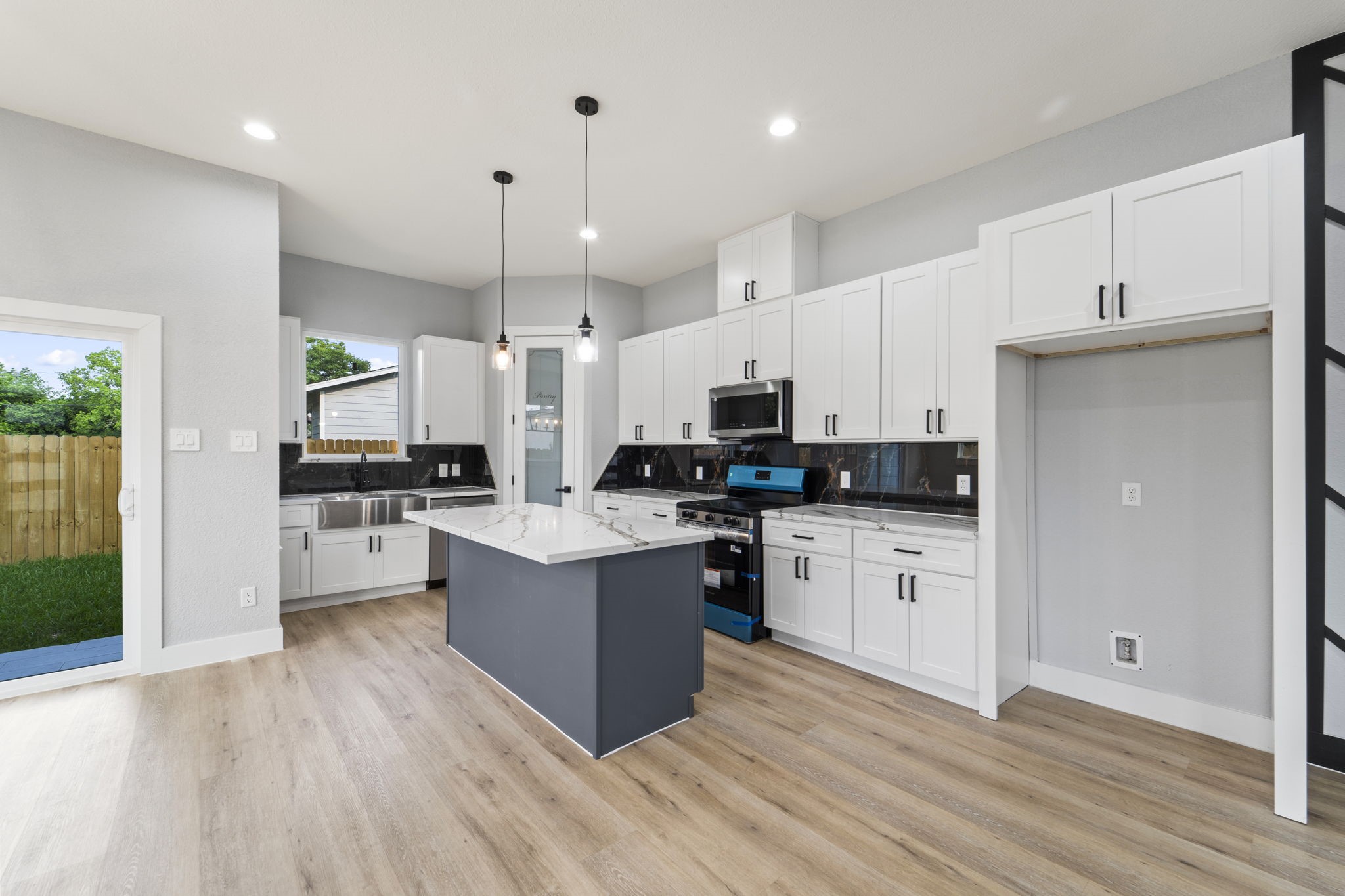 6631 Foster Street Houston, TX 77021 - Photo 7 of 31 a kitchen with cabinets wooden floor and stainless steel appliances