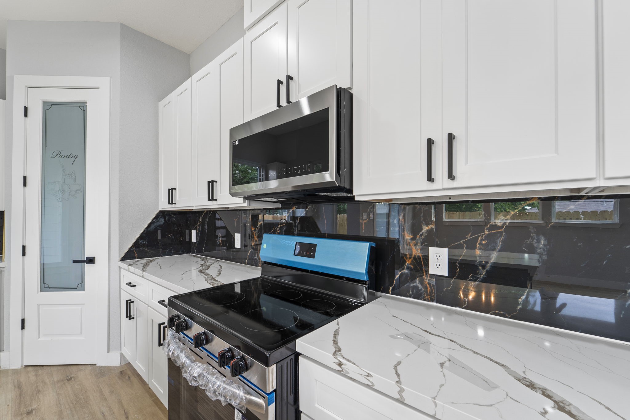 6631 Foster Street Houston, TX 77021 - Photo 9 of 31 a kitchen with a stove and a microwave