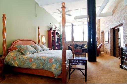 1000 West Washington Boulevard, Unit 406 Chicago, IL 60607 - Photo 6 of 8 a bedroom with a bed and a table