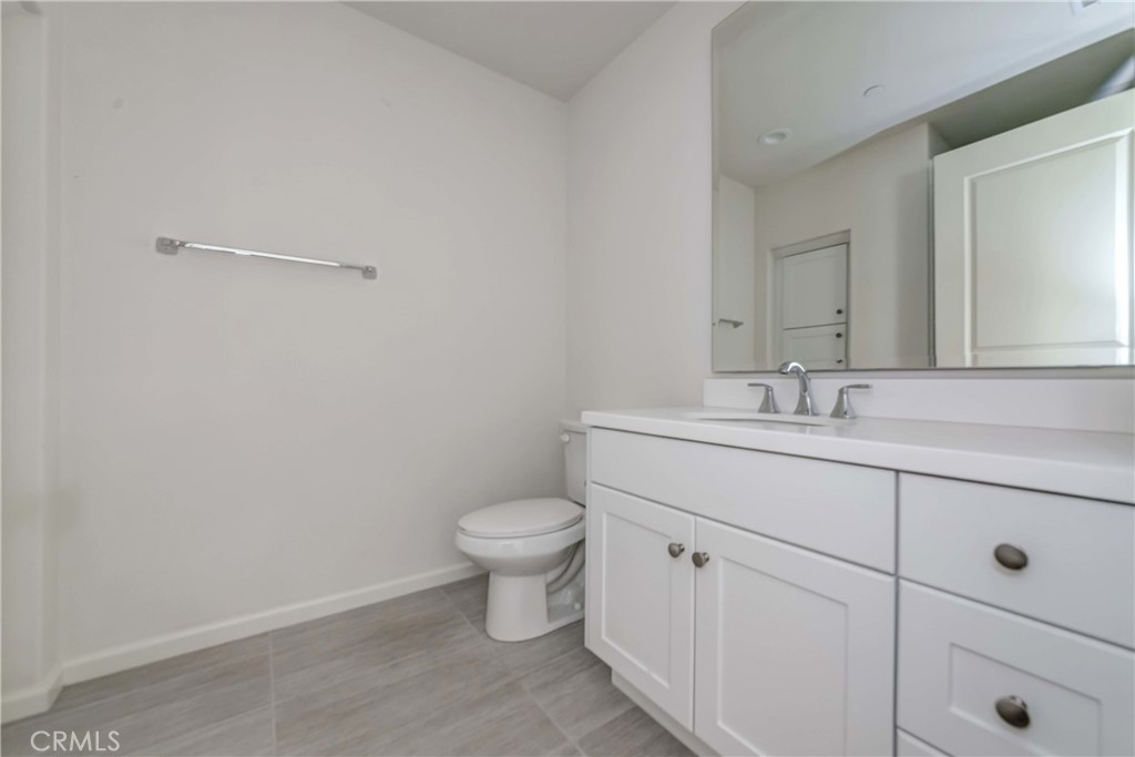 118 Walking Stick Irvine, CA 92618 - Photo 2 of 26 a bathroom with a toilet sink and mirror