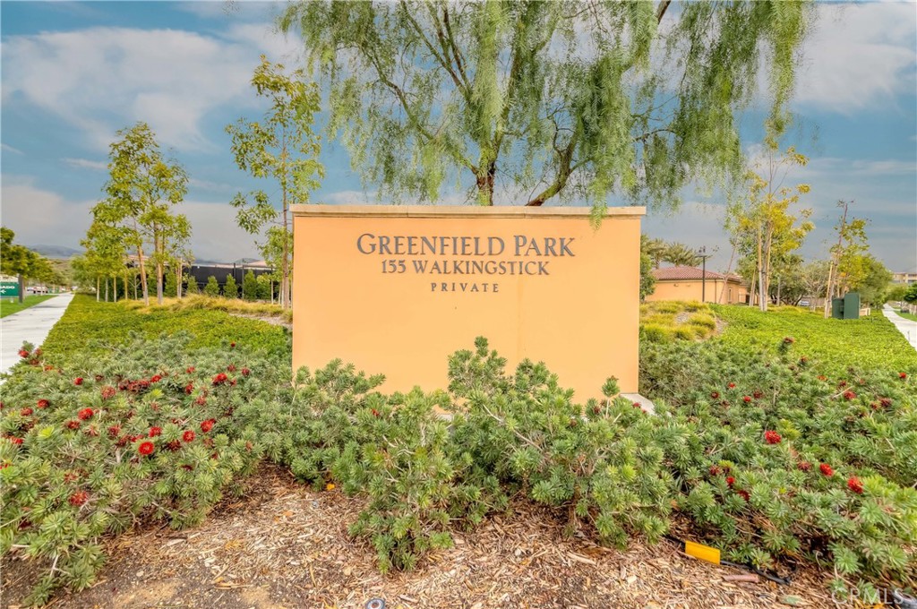118 Walking Stick Irvine, CA 92618 - Photo 23 of 26 a sign of golf club on a wall under a large tree