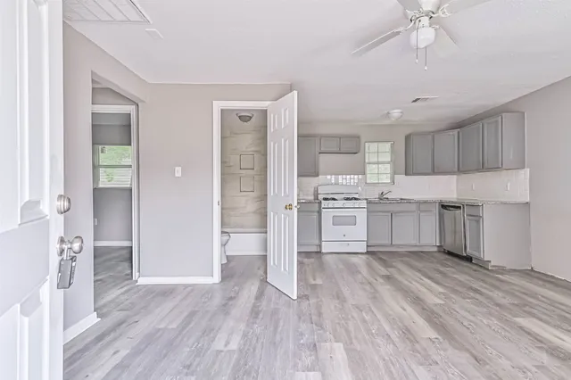 a kitchen with white cabinets and stainless steel appliances