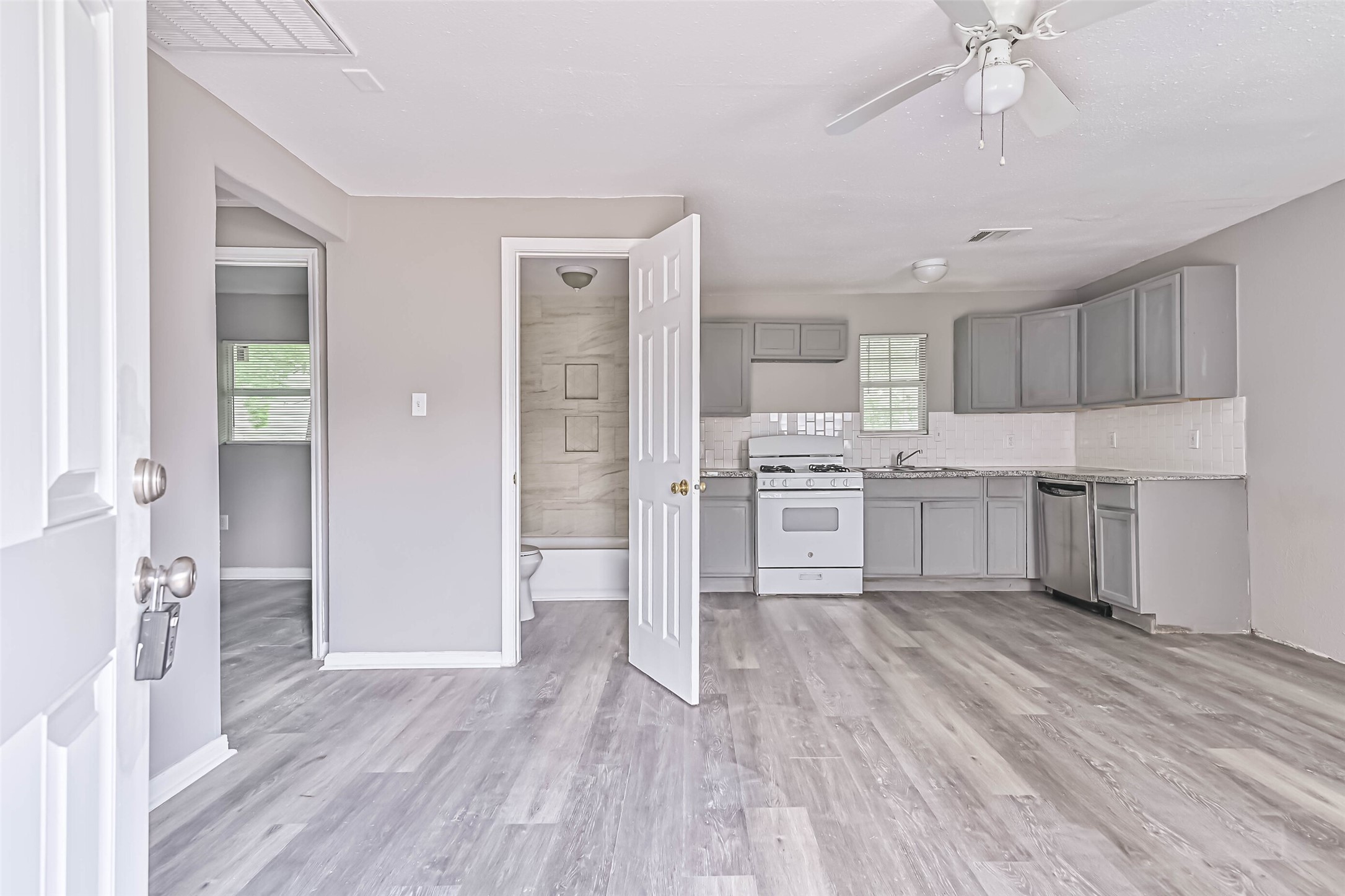 a kitchen with white cabinets and stainless steel appliances