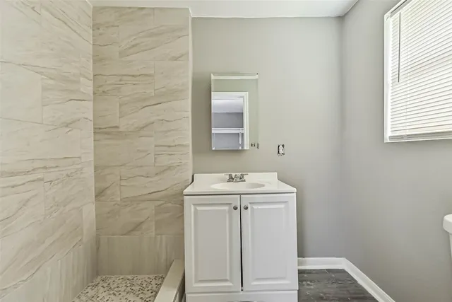 a bathroom with a sink a toilet and window