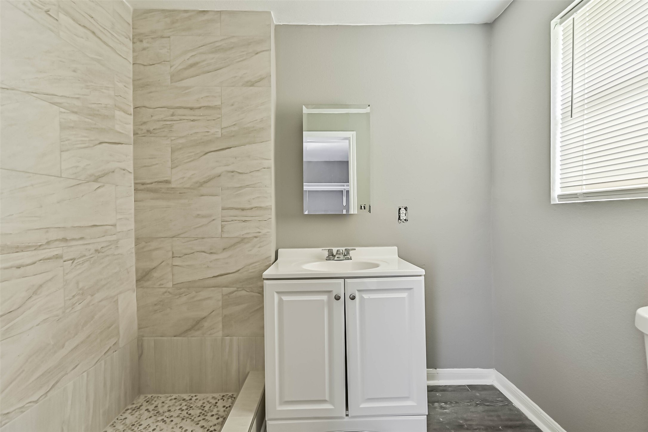 9839 Racine Street, Unit 1/2 Houston, TX 77029 - Photo 19 of 26 a bathroom with a sink a toilet and window