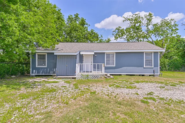 a house that has a big yard and large trees