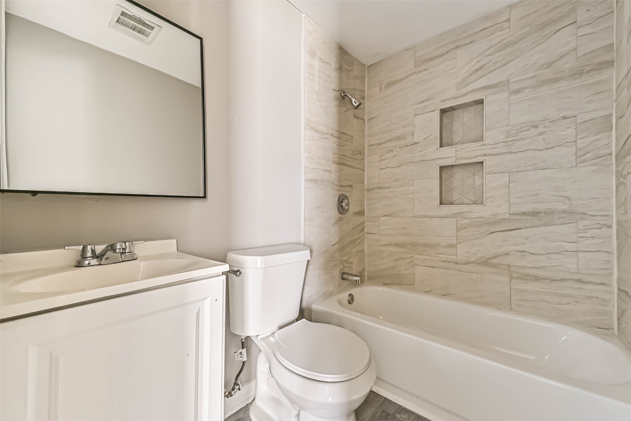 9839 Racine Street, Unit 1/2 Houston, TX 77029 - Photo 4 of 26 a bathroom with a sink toilet and shower