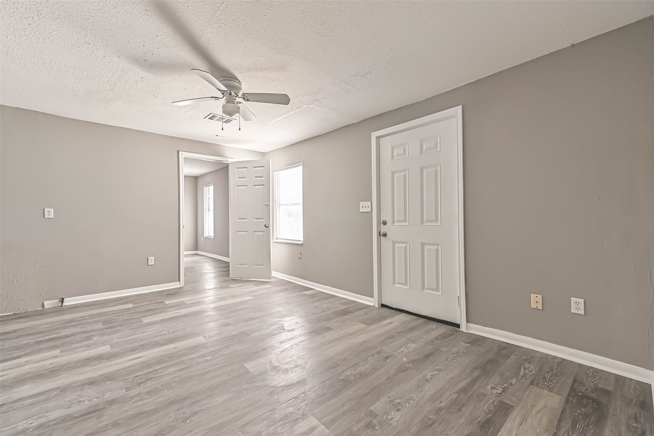 9839 Racine Street, Unit 1/2 Houston, TX 77029 - Photo 6 of 26 wooden floor in an empty room with a window