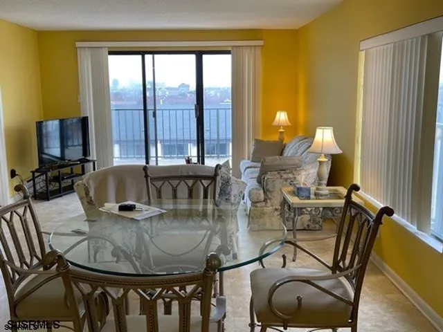 a dining room with furniture and wooden floor