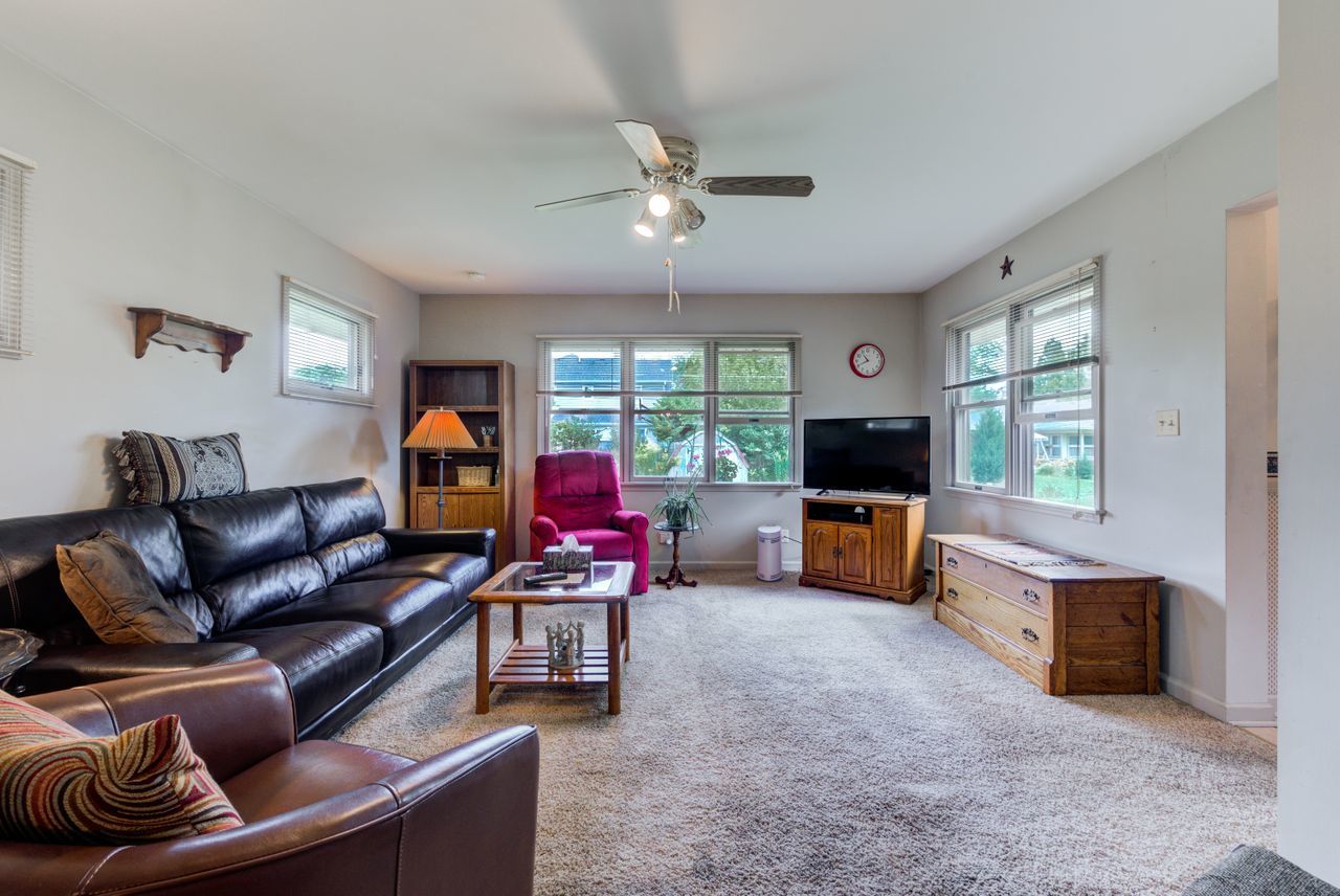 122 Wilma Place Park Ridge, IL 60068 - Photo 9 of 20 a living room with furniture a fireplace and a flat screen tv