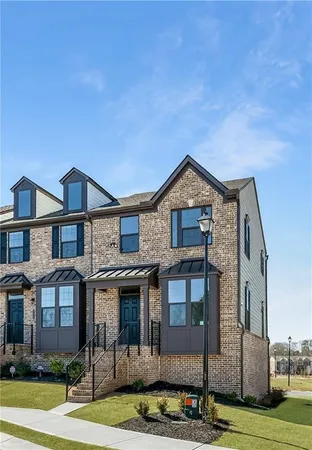 a view of a brick house next to a yard