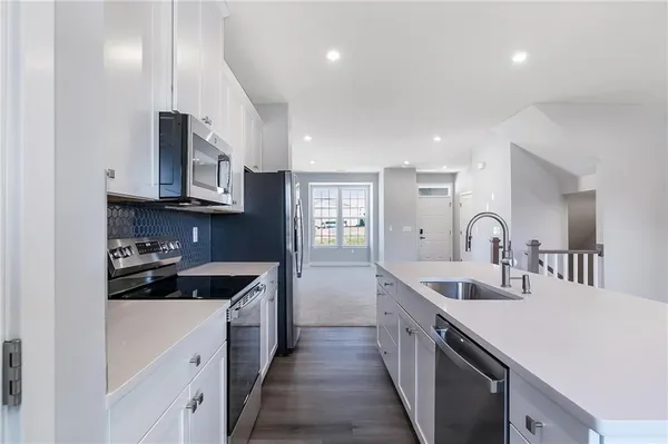 a kitchen with stainless steel appliances granite countertop a sink and cabinets