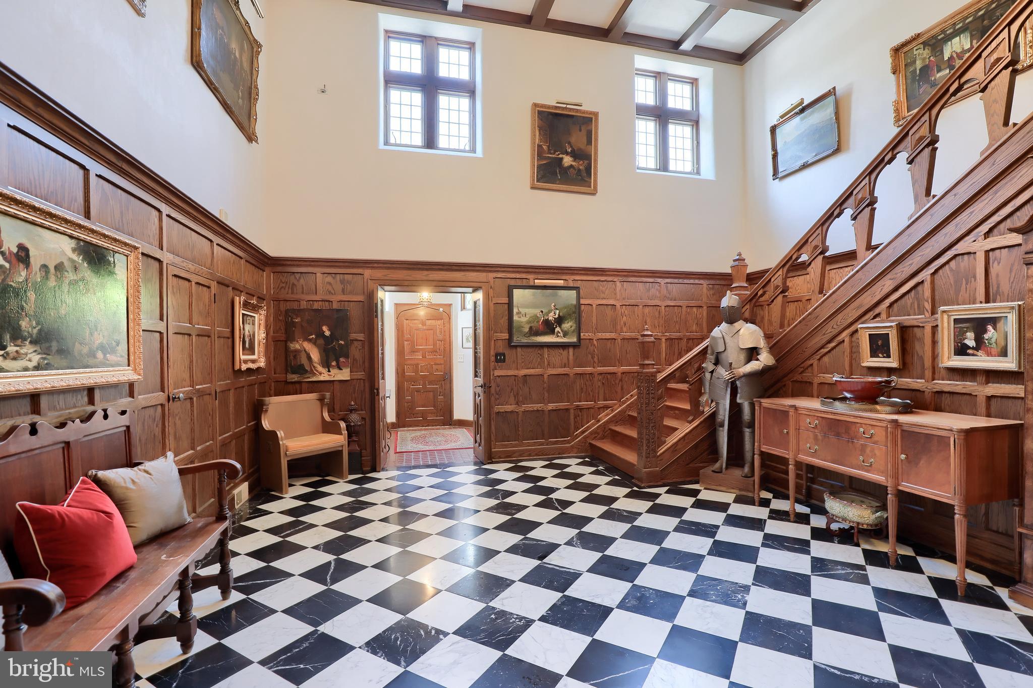 80 School House Road Lancaster, PA 17603 - Photo 11 of 87 a living room with a black white checkered floor with a gaming machine and wooden floor