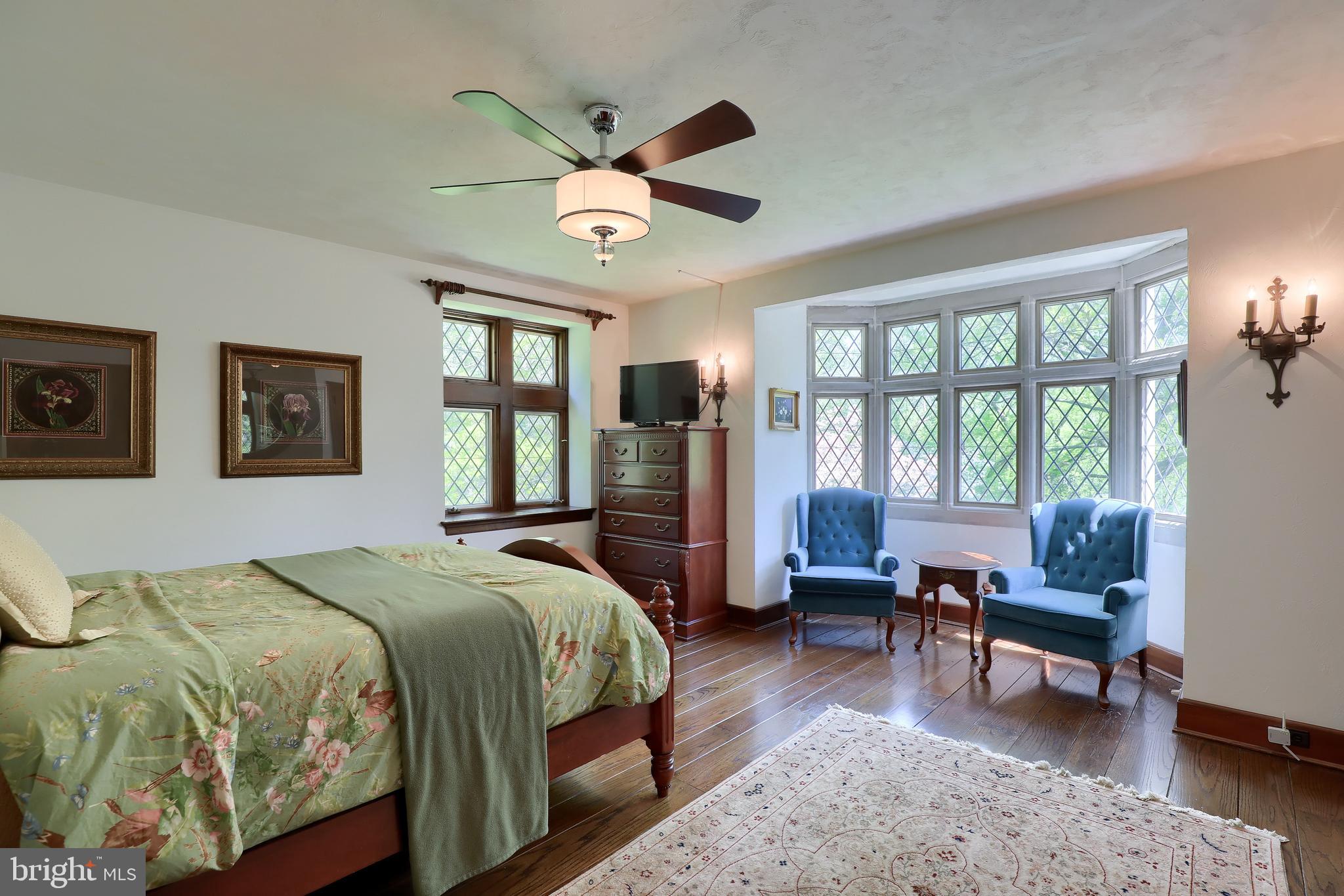 80 School House Road Lancaster, PA 17603 - Photo 34 of 87 a bedroom with a large bed a chandelier and a window