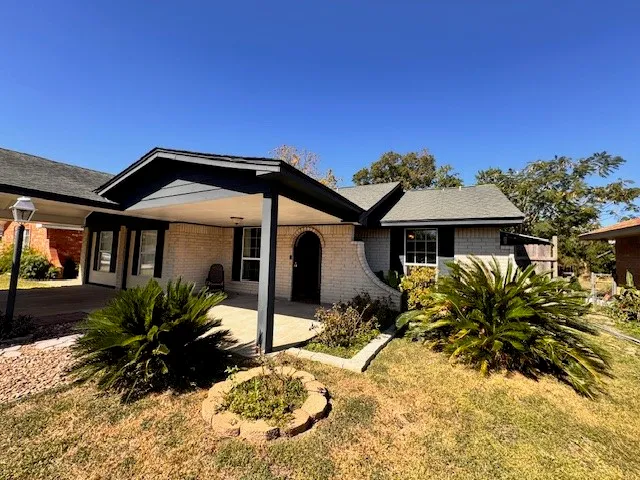 a front view of house with yard outdoor seating and barbeque oven