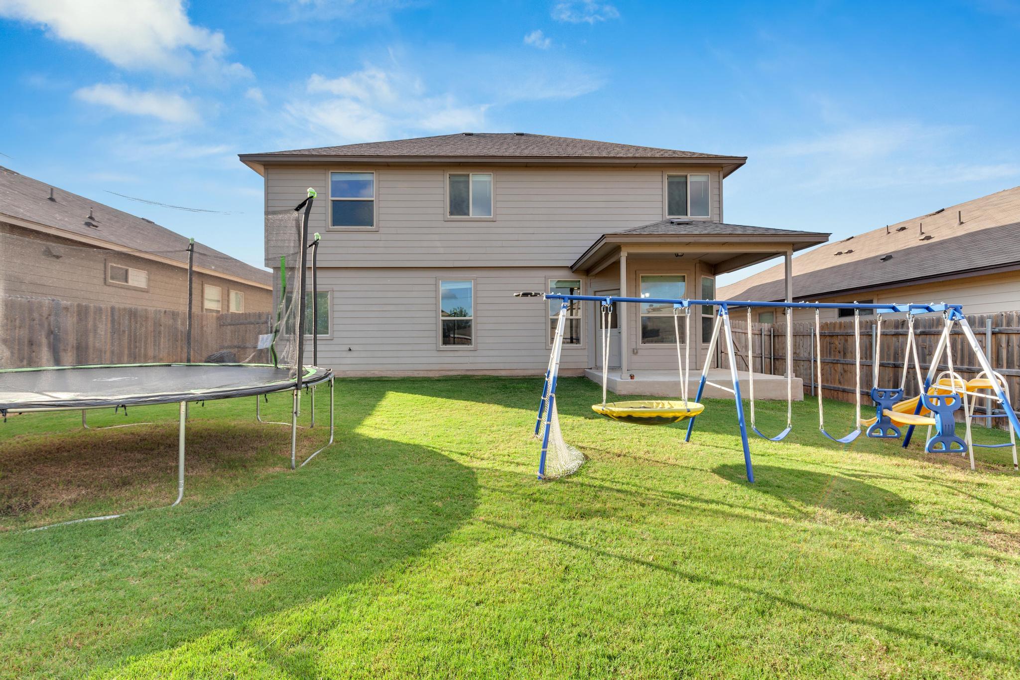104 Uncle Billy Way Jarrell, TX 76537 - Photo 34 of 38 A vibrant backyard with lush green grass, perfect for outdoor activities and relaxation.