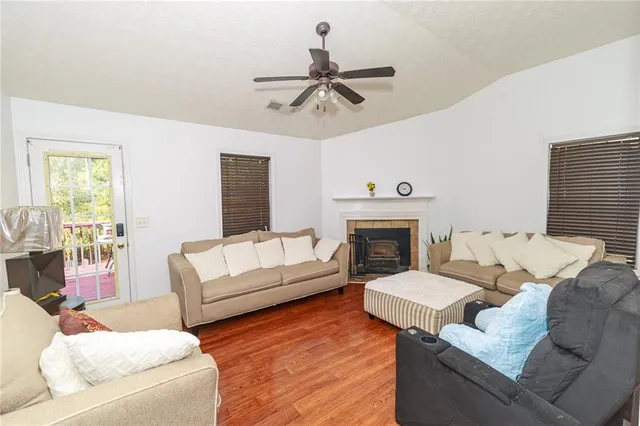 a living room with furniture a fireplace and a large window