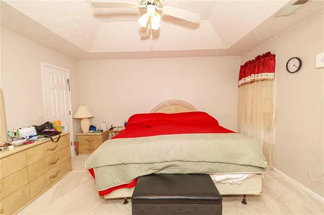 a bedroom with a bed and a couch