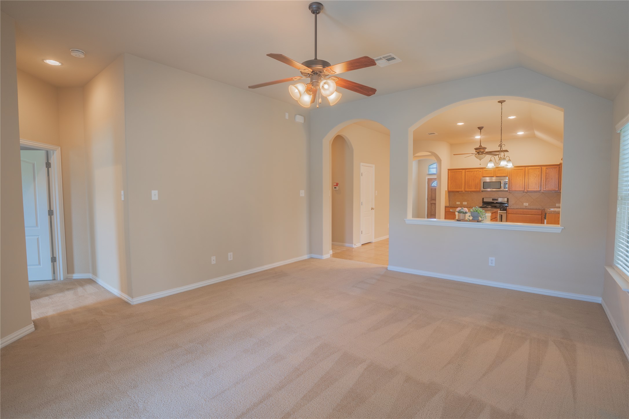 403 Tascate Street Georgetown, TX 78628 - Photo 9 of 26 An inviting open-concept layout connects the living space to a modern kitchen.