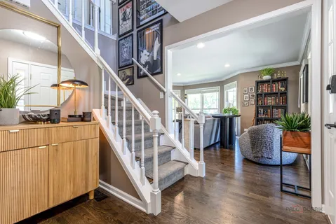 a view of entryway and hall with wooden floor