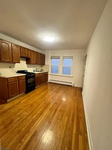 a view of kitchen with wooden floor