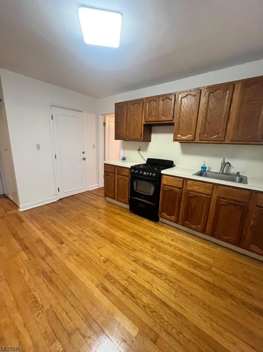 321 Amon Terrace, Unit 1 Linden, NJ 07036 - Photo 4 of 15 a kitchen with stainless steel appliances granite countertop a sink stove and cabinets