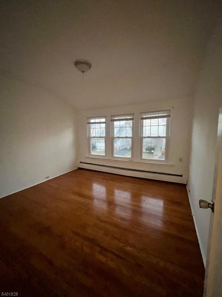 321 Amon Terrace, Unit 1 Linden, NJ 07036 - Photo 5 of 15 an empty room with wooden floor and windows